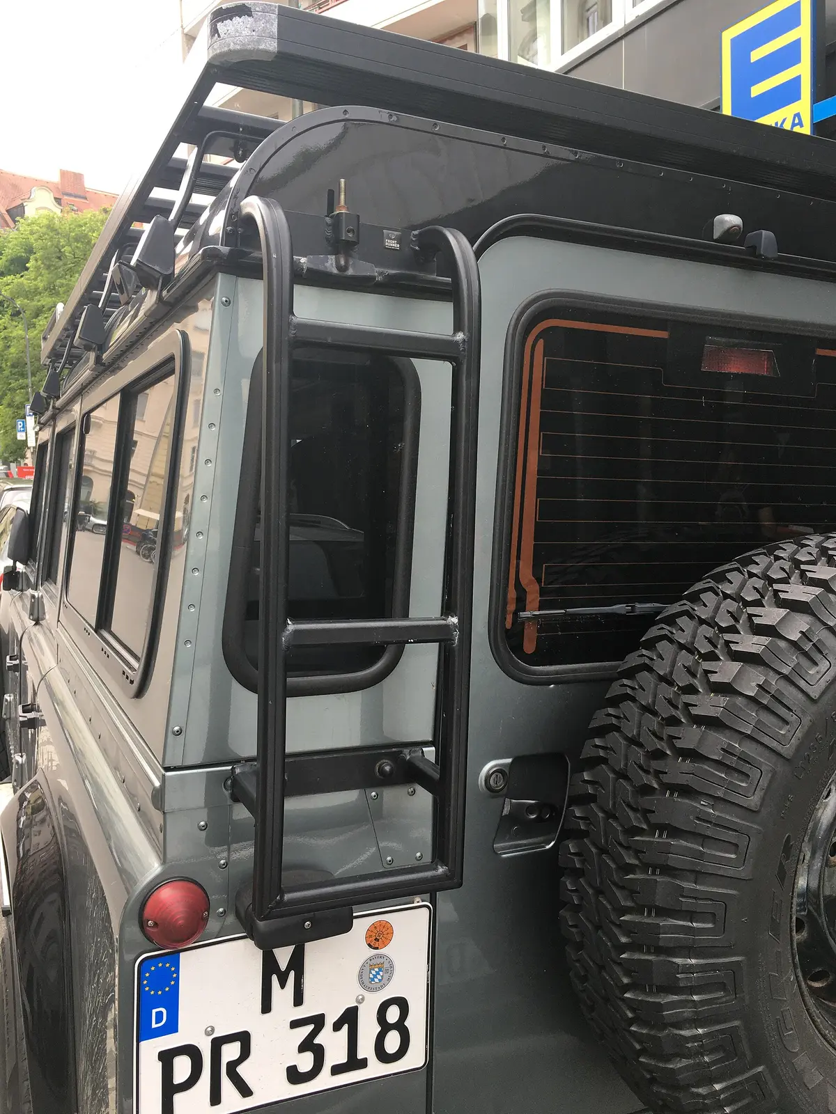 Rear of a Defender with roof rack, ladder and spare wheel